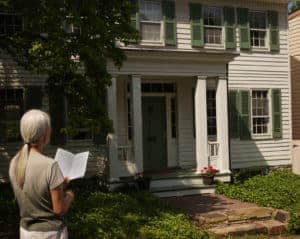 Tourist visiting Waterford Virginia using a walking guide